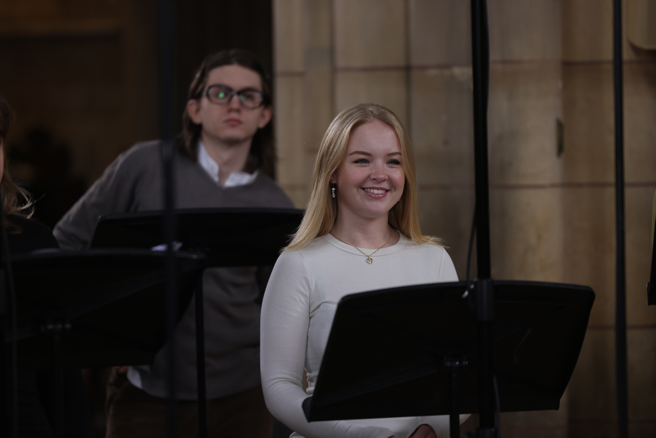 Phoenix Consort soprano singer smiling during cathedral rehearsal