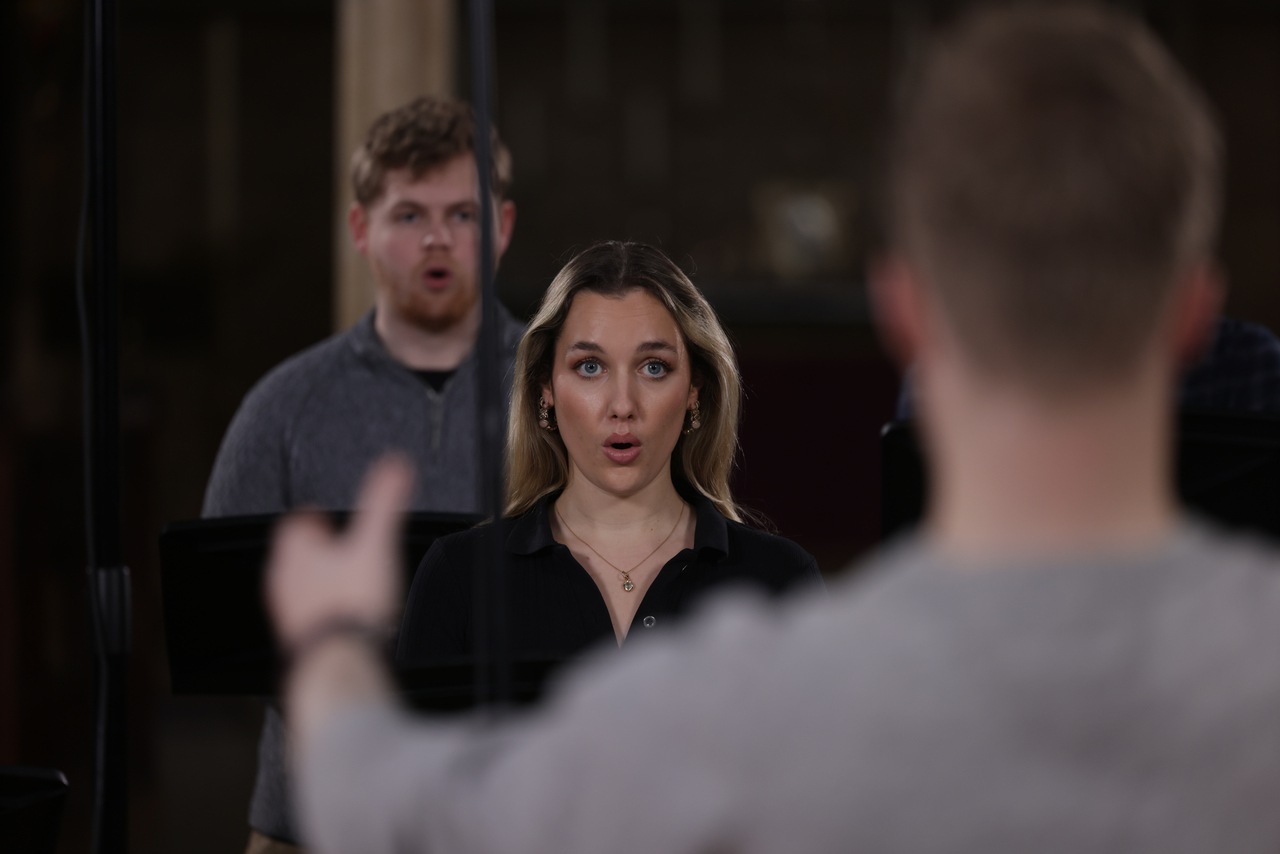 Phoenix Consort singer focused on conductor Adam Whitmore during cathedral performance