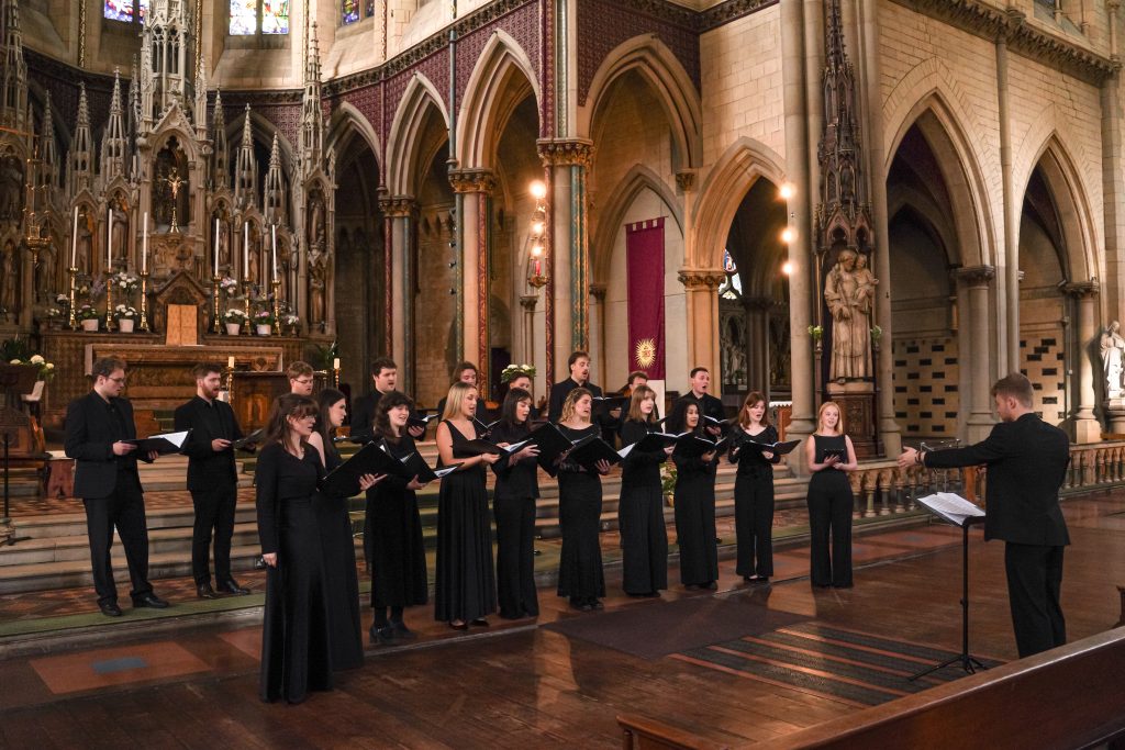 The Phoenix Consort performing in a Gothic cathedral directed by Adam Whitmore